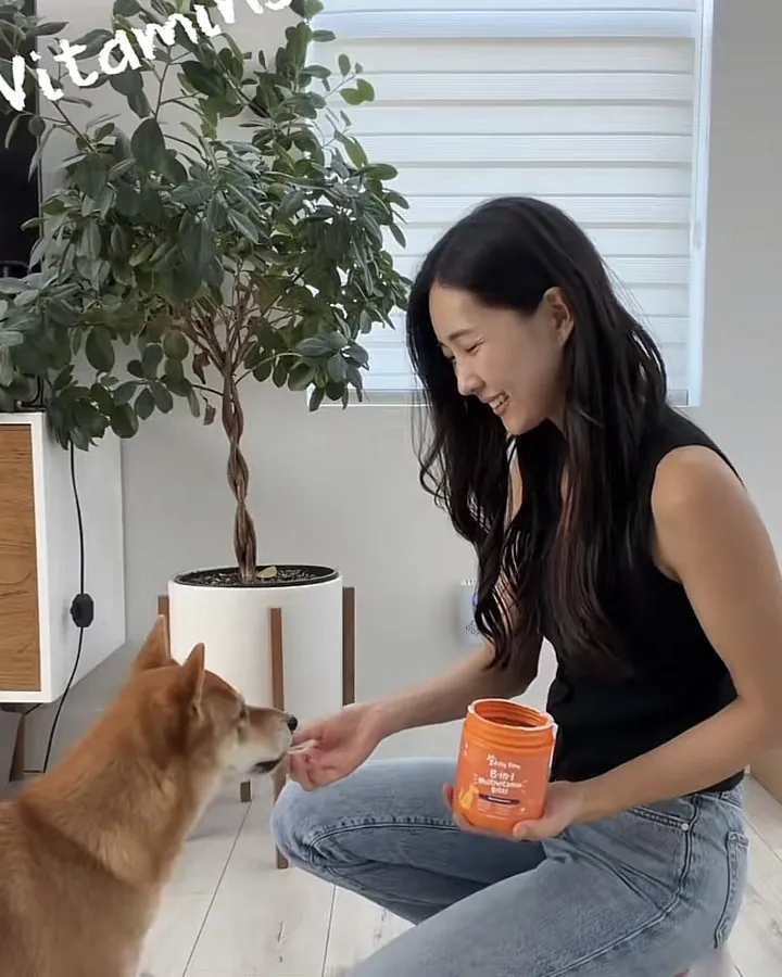 A creator filming pet content on set with her dog